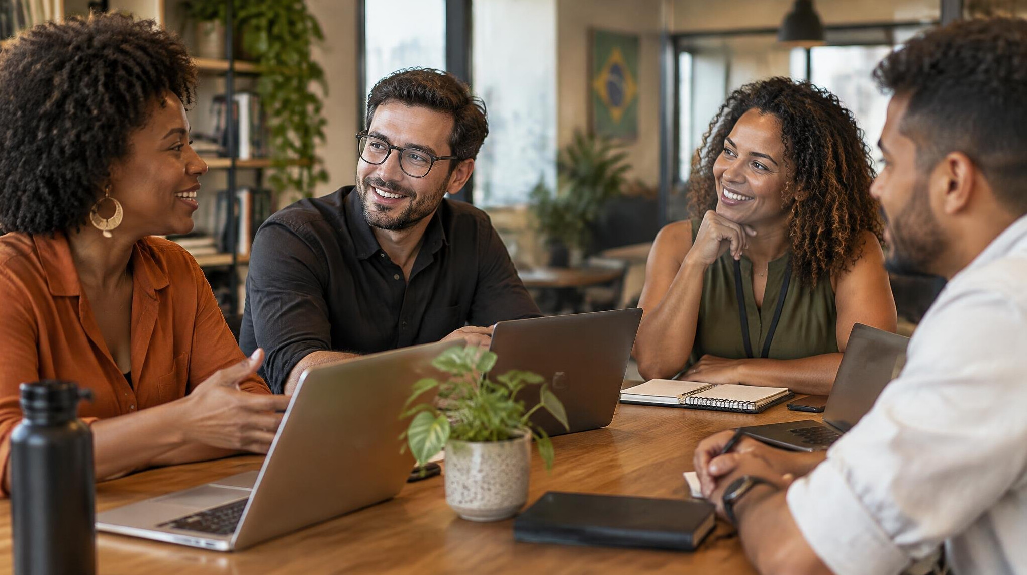 Group of colleagues talking around a table in a modern office